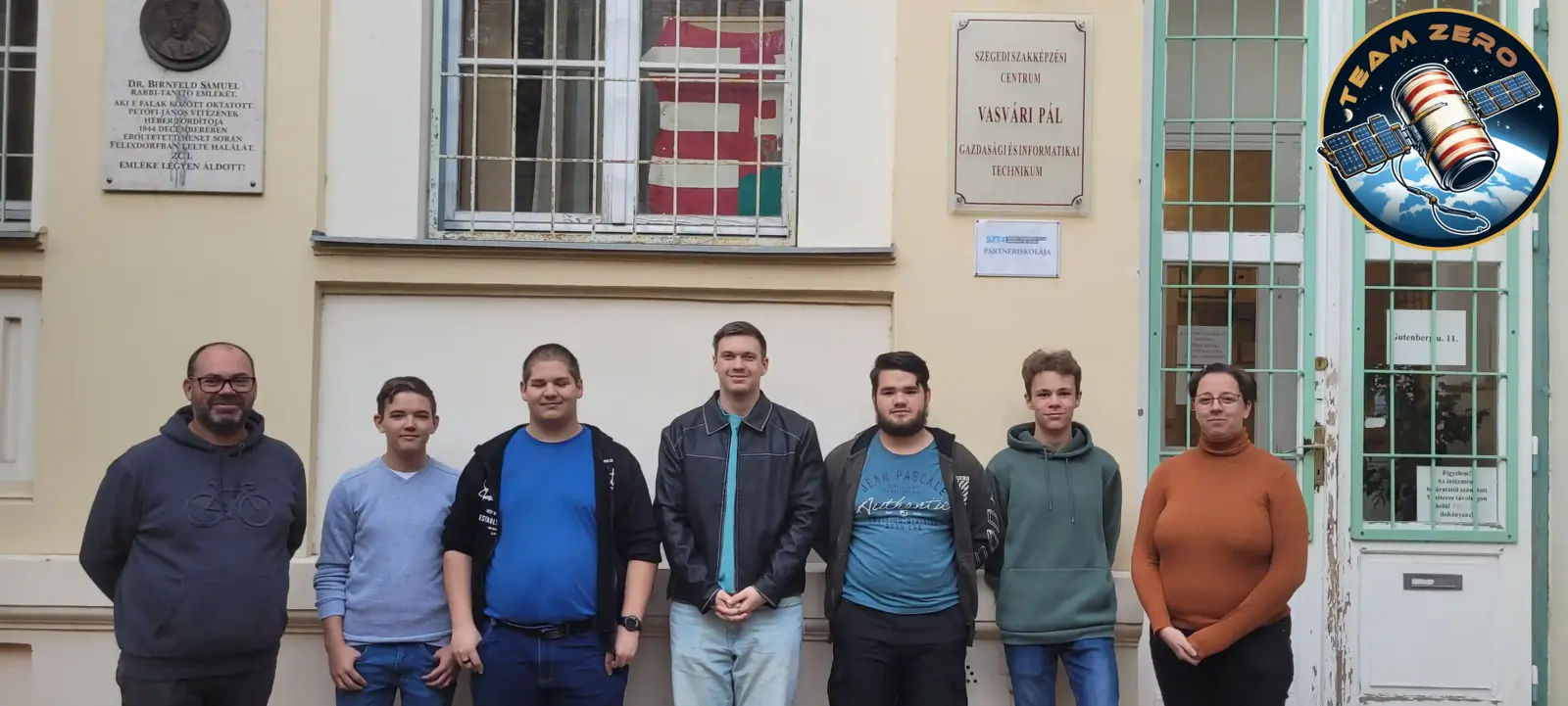 The team and the mentors in front of our school
